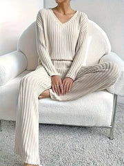 Off-white ribbed knit V-neck loungewear set with long sleeves and wide-leg pants.