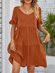 Caramel ruffled sleeve mini dress with v-neck and tiered skirt.