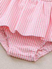 Pink striped seersucker one-piece swimsuit with ruffled detail and elasticized leg openings.