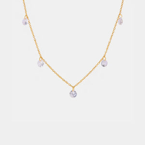 Gold dangling crystal station necklace with five clear cubic zirconia charms.