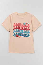 Tan t-shirt with stacked "America" graphic and flowers, 70s-inspired style