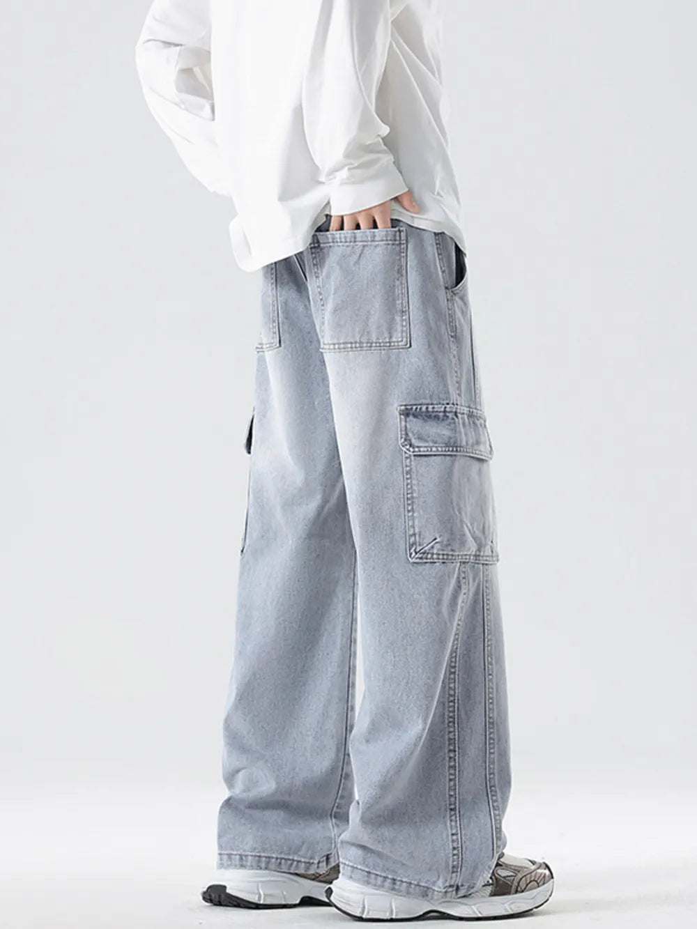 Light blue oversized cotton cargo jeans with drawstring waist and multiple pockets.