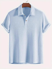 Light blue textured polo shirt with rolled sleeves and a two-button placket.