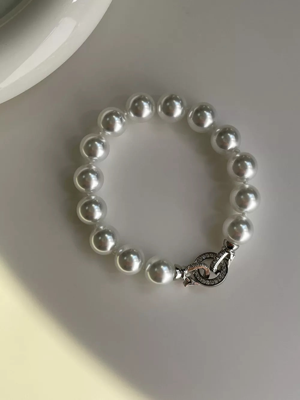 White pearl beaded bracelet with ornate clasp