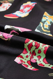 Black silk pajama set with a colorful boot print pattern.