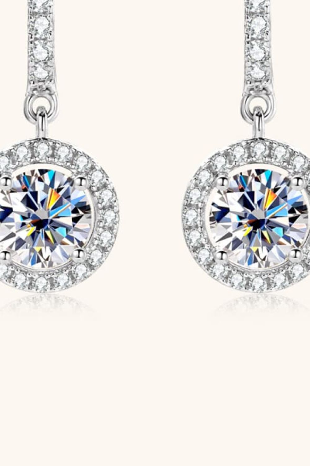 Silver pavé halo drop earrings with a large round center stone.