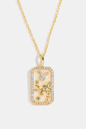 Taurus zodiac sign crystal pendant necklace, 14K gold-plated with rhinestones and turquoise accents.