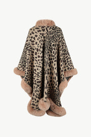 Leopard print acrylic cape with faux fur trim in beige, featuring a cozy collar and hem detail.