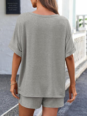 Gray relaxed fit tee with cuffed short sleeves and matching shorts.