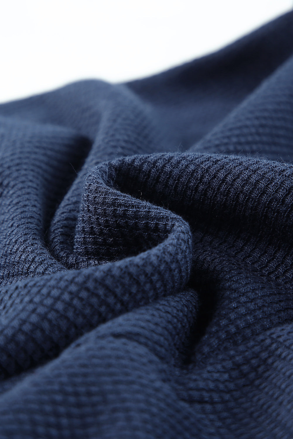 Navy jersey jumpsuit fabric detail with waffle texture