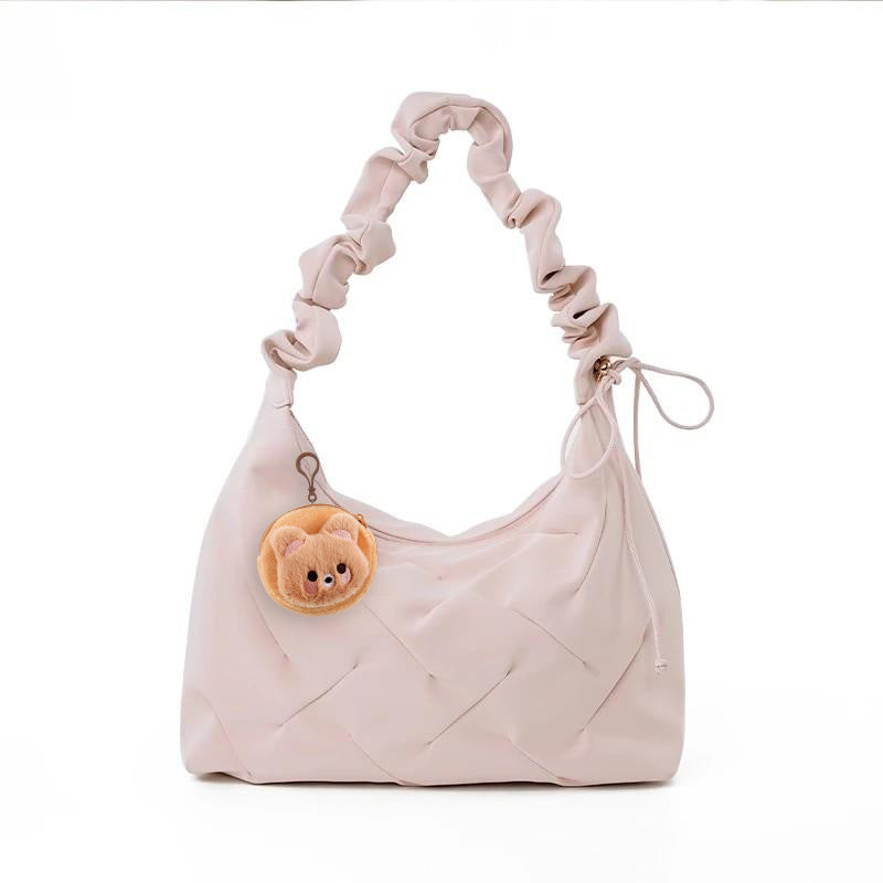 Blush pink ruched shoulder bag with a cute bear charm and quilted detail.