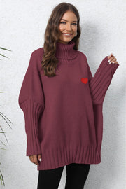 Burgundy knit turtleneck sweater with batwing sleeves and a red heart embroidery detail.
