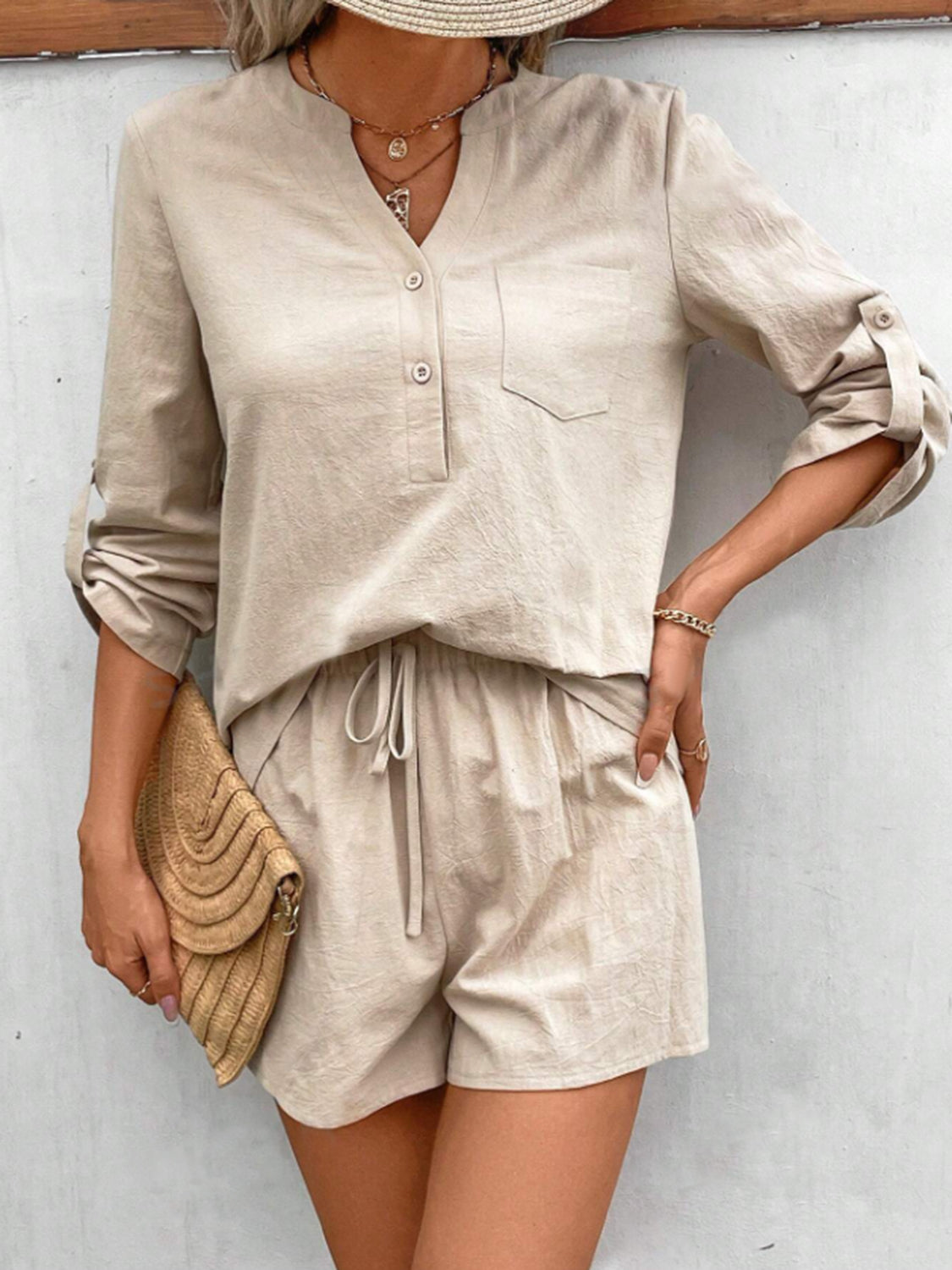Tan linen henley shirt with rolled sleeves and drawstring shorts set.