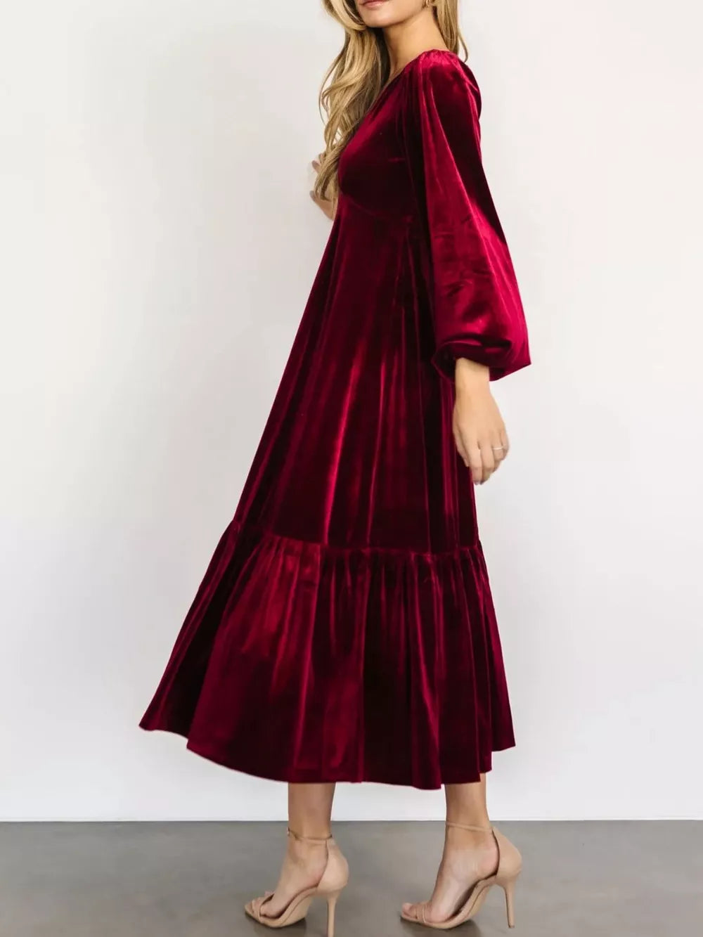 Burgundy velvet midi dress with tiered skirt and puff sleeves.