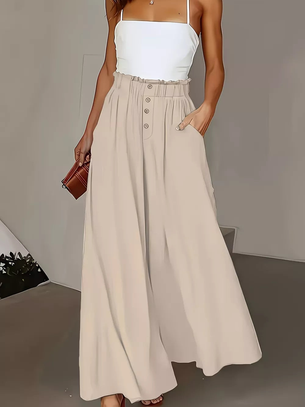 Beige wide-leg trousers with paperbag waist and button detail.