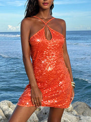 Orange sequin backless mini dress with halter neckline and keyhole cutout.