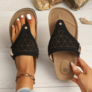 Black hollow-out toe-post sandals with adjustable ankle strap and cork-style footbed.