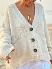 Beige bouclé knit oversized button-down cardigan with V-neck and pockets.