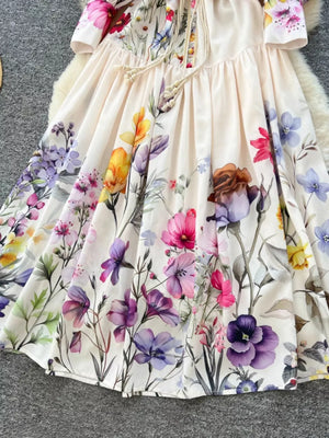 Vibrant floral midi dress with lantern sleeves and a drawstring neckline.