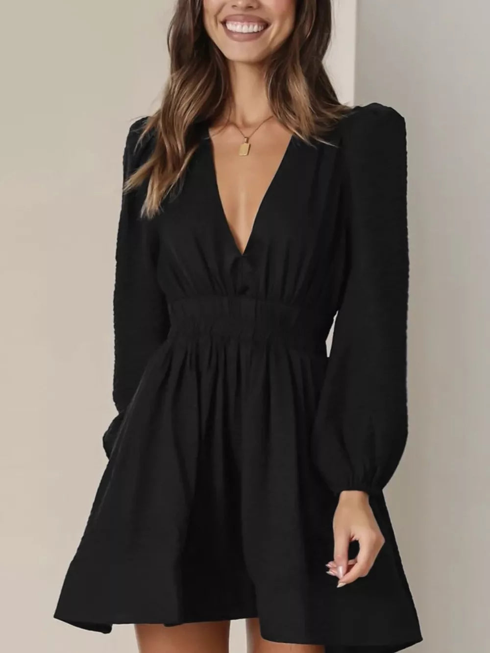 Black V-neck mini dress with puff sleeves and cinched waist