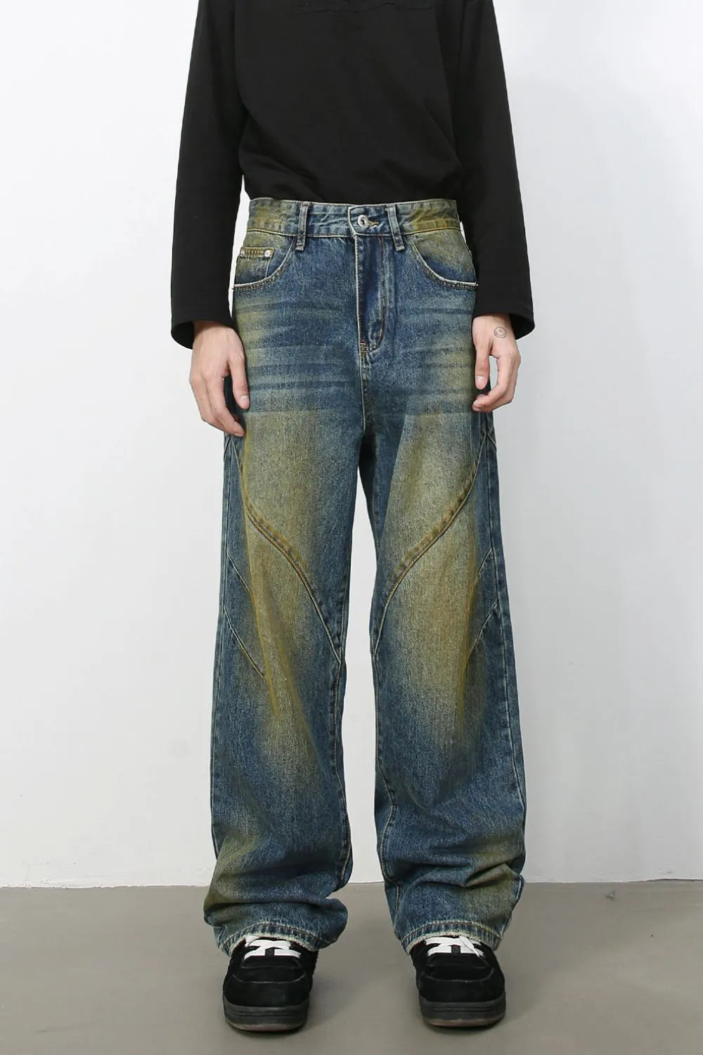 Panelled acid wash wide leg jeans in medium blue denim with yellowing accents.