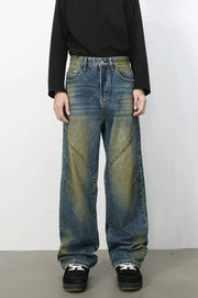 Panelled acid wash wide leg jeans in medium blue denim with yellowing accents.