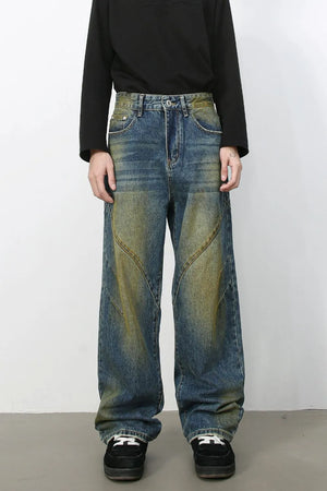 Panelled acid wash wide leg jeans in medium blue denim with yellowing accents.