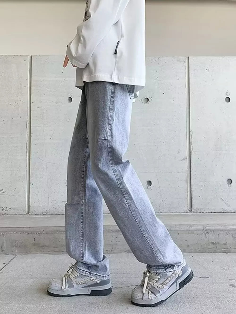 Men's light wash wide-leg jeans with a vintage look.