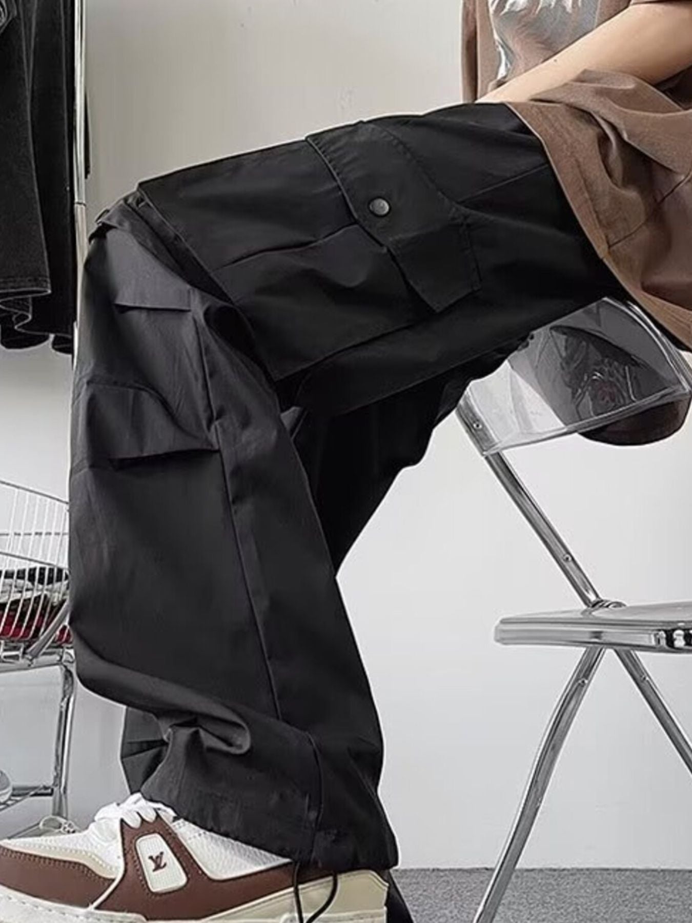 Black wide-leg cargo pants with multiple flap pockets and a relaxed fit.