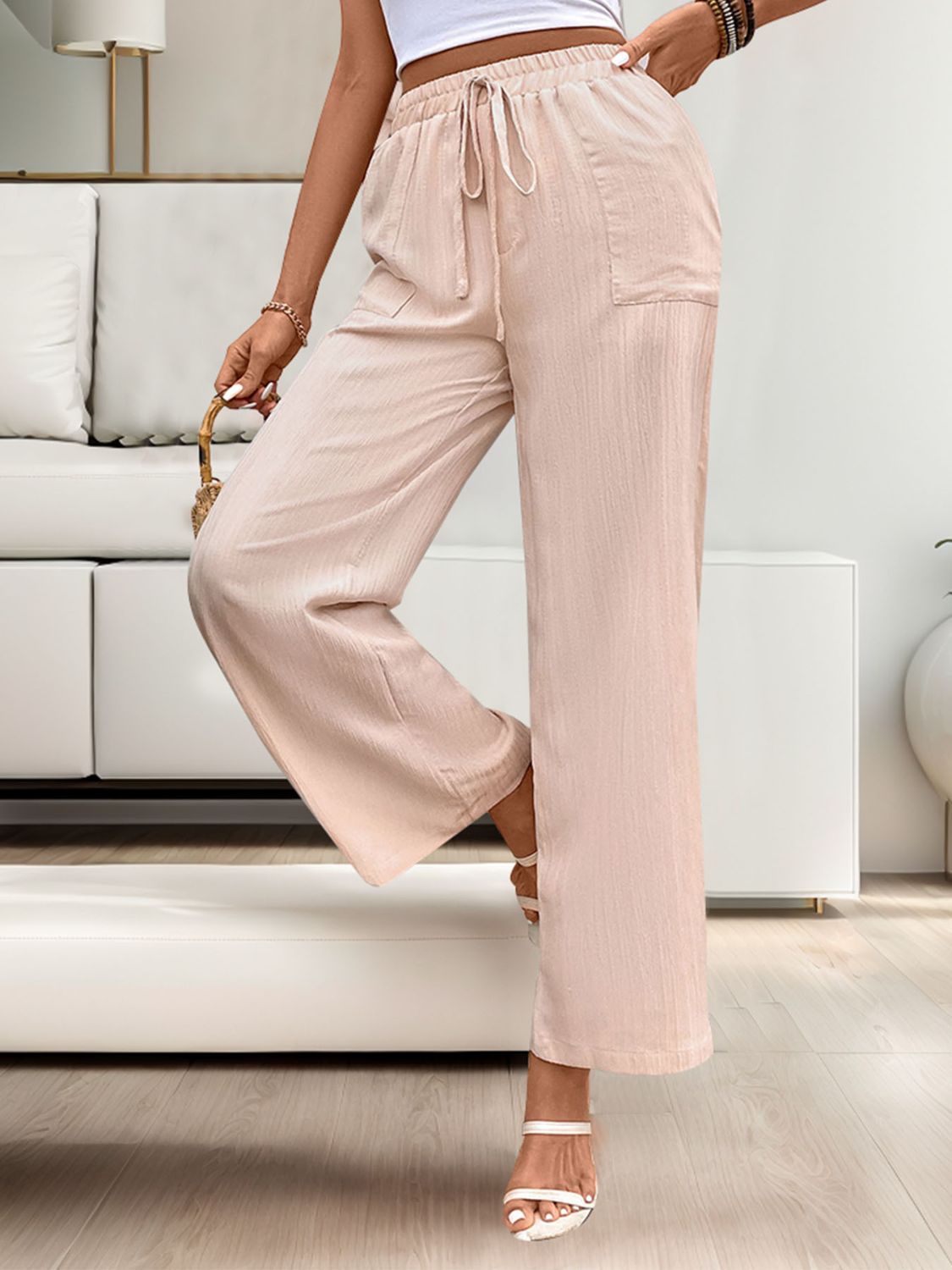 Apricot linen palazzo pants with drawstring waist and pockets.