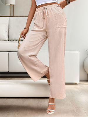 Apricot linen palazzo pants with drawstring waist and pockets.