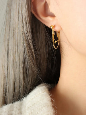 Gold interlocking chain drop earrings with a ball stud and layered chains.
