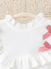 White ribbed toddler top with ruffled neckline and pink bows