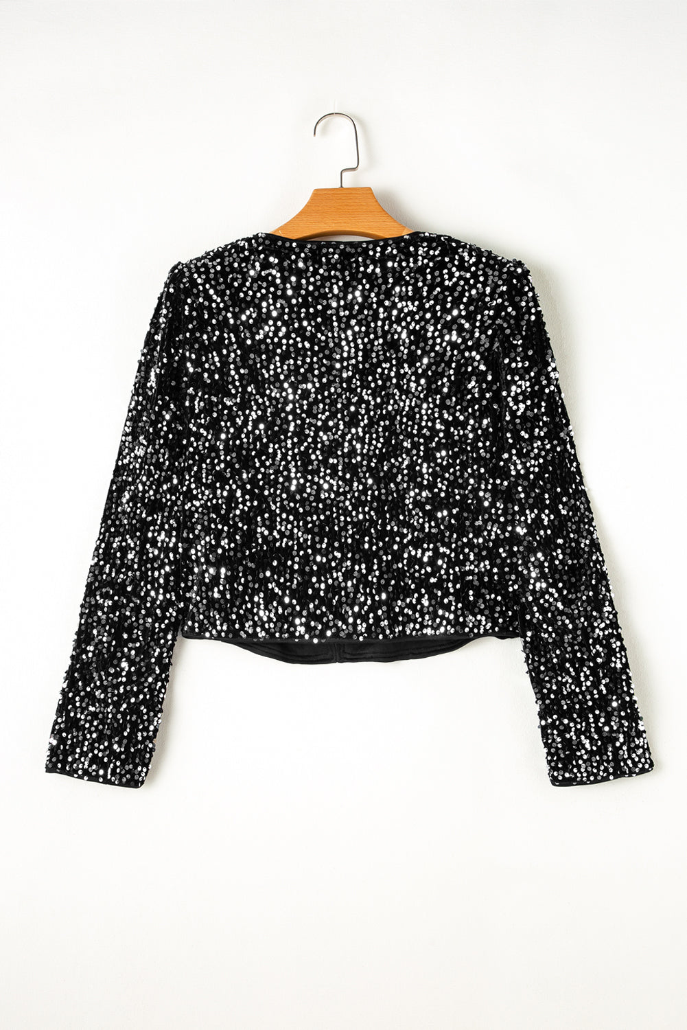 Black sequin embellished cropped open jacket with long sleeves.