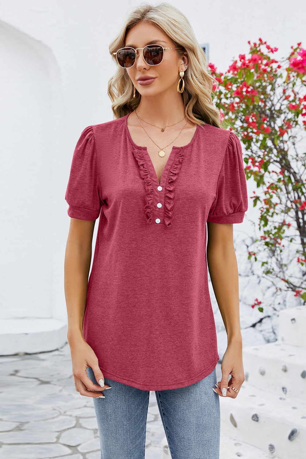 Watermelon pink tee with ruffled placket, button detail, and puff sleeves.