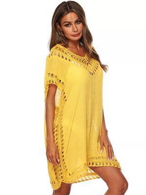 Yellow crochet V-neck cover-up dress with cutout details and fringe hem.
