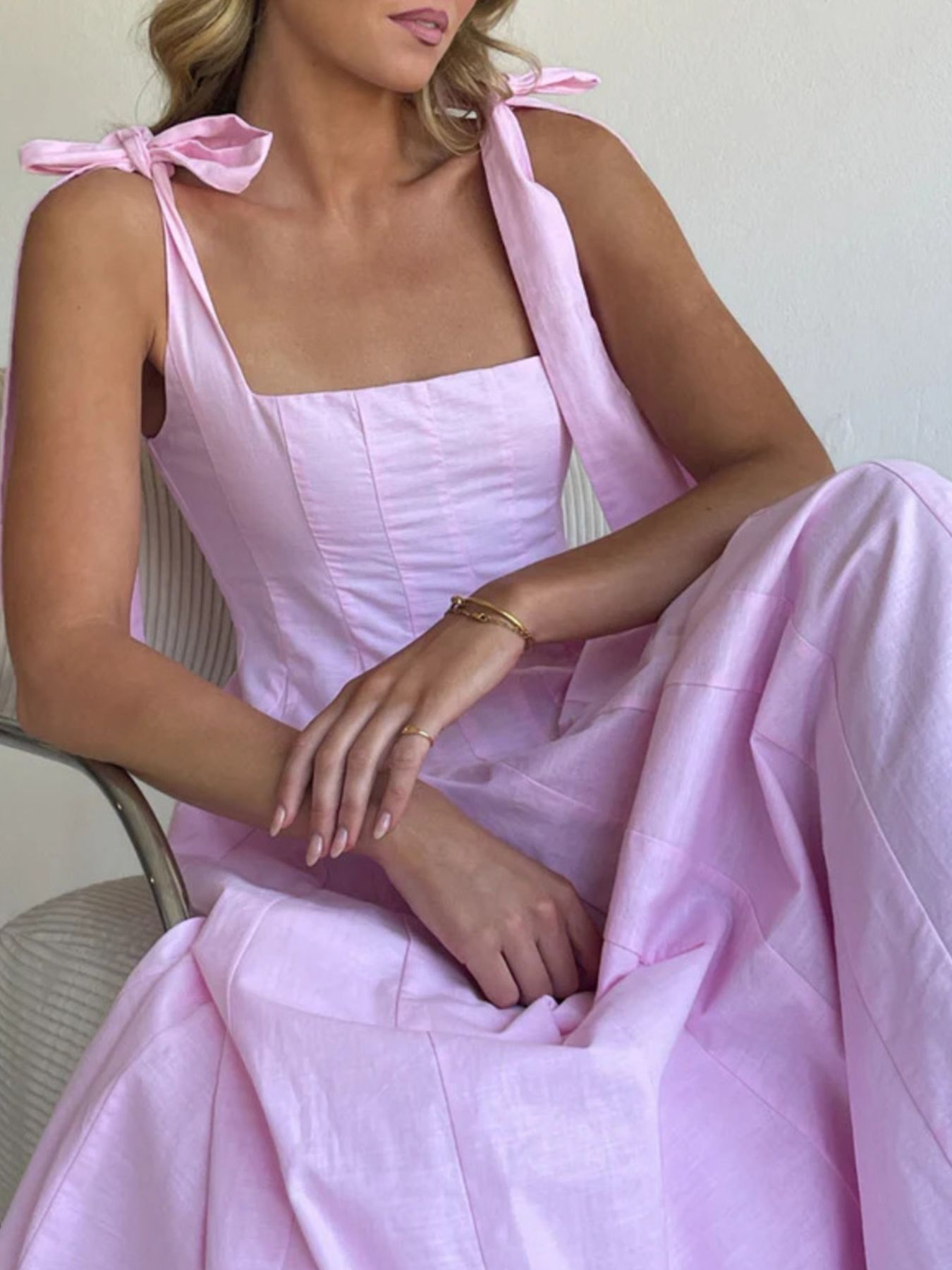 Pink bow-tie shoulder maxi dress with square neckline and full skirt.
