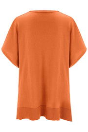 Relaxed V-neck knit poncho top in pumpkin with short sleeves and ribbed hem.