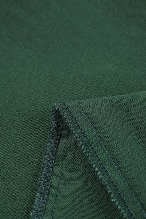 Green cotton jeans with crossed v-waist detail and visible stitching.