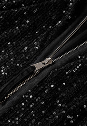 Black sequin bomber jacket with silver zipper detail and ribbed trim.