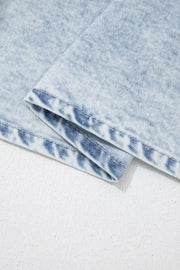 Light wash denim top with ruffled accents, cap sleeves, and cotton blend fabric.
