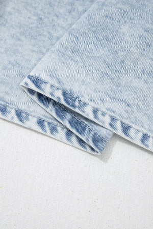 Light wash denim top with ruffled accents, cap sleeves, and cotton blend fabric.