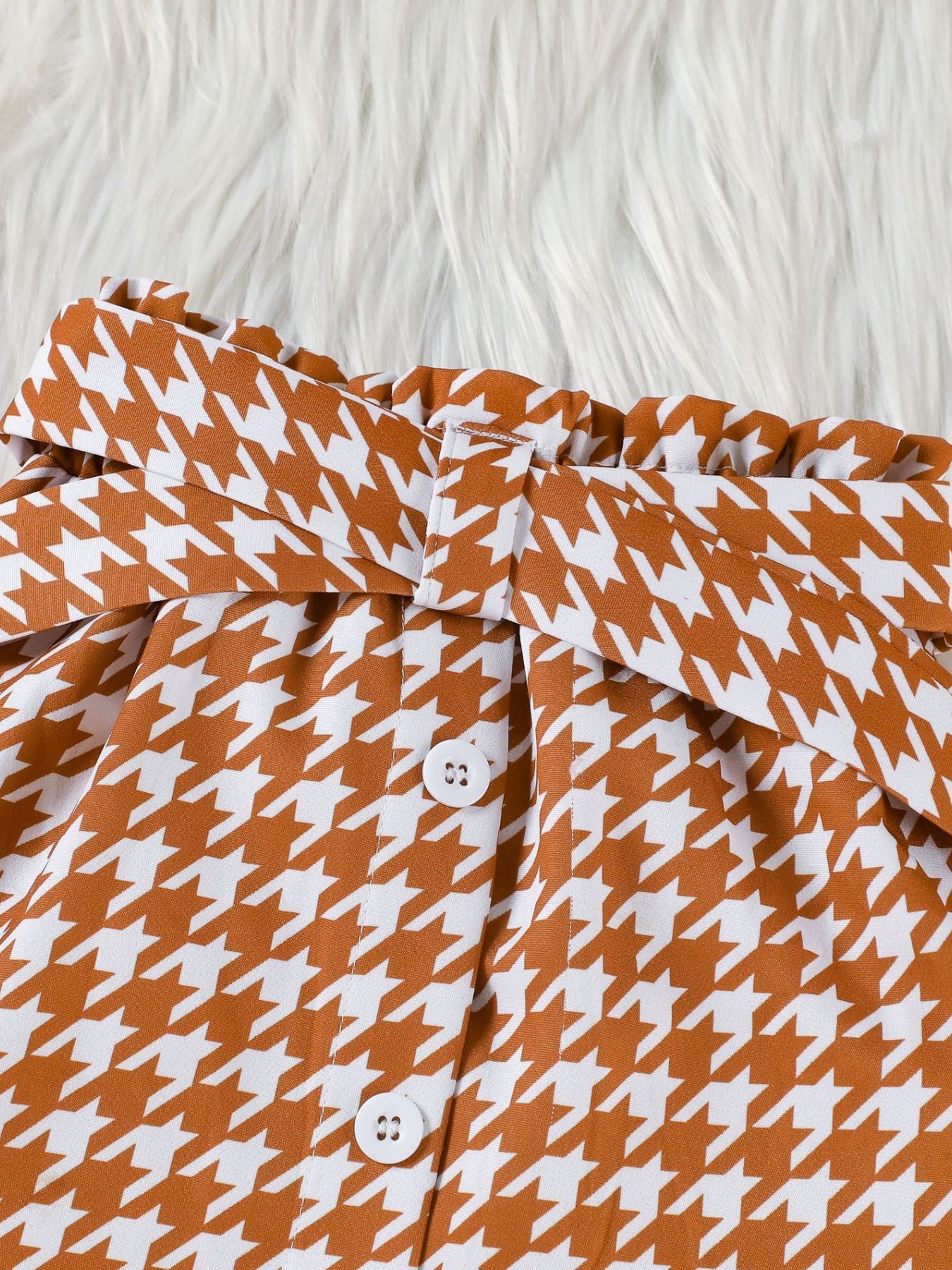 Toddler houndstooth skirt with paperbag waist, tie belt, and button details.