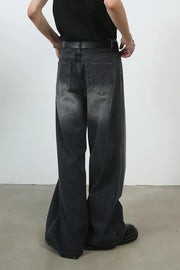 Black faded wash palazzo jeans with a wide leg and pleated detail.