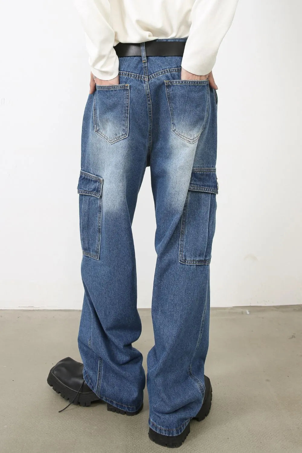 Faded denim cargo pants with multiple pockets and a relaxed fit.