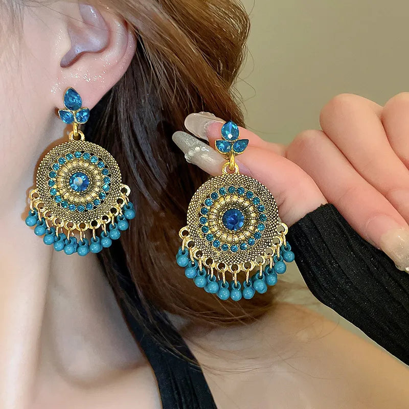 Cerulean beaded medallion and pearl drop earrings with gold alloy accents.