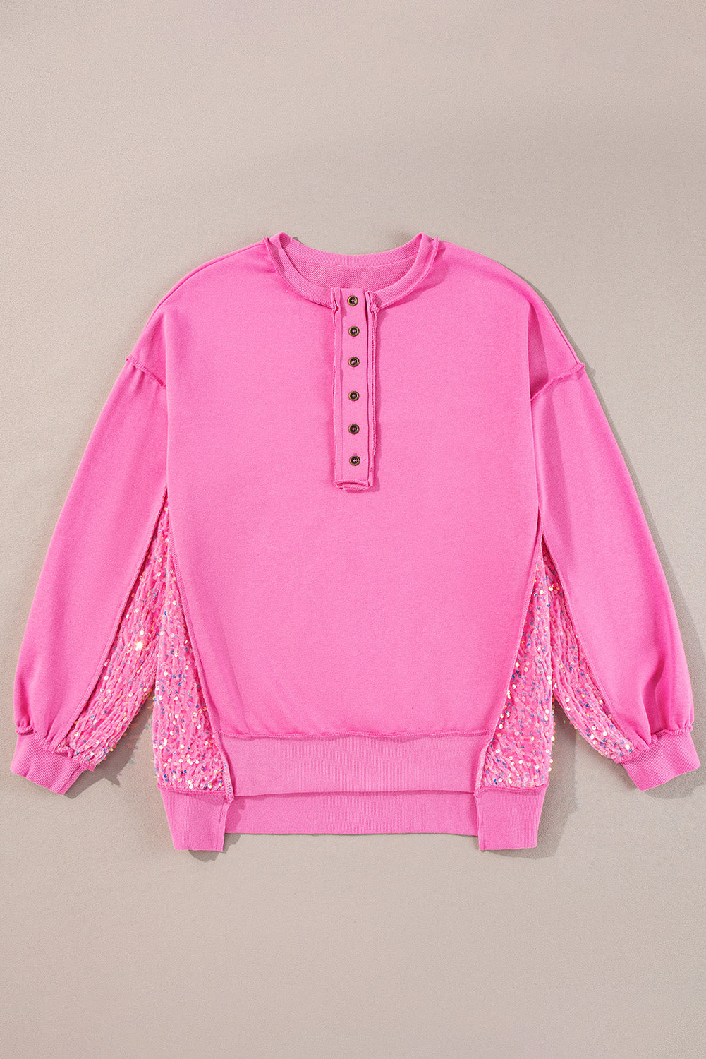 Fuchsia pink sweatshirt with button henley neckline and sequin side panels.