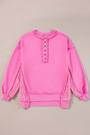 Fuchsia pink sweatshirt with button henley neckline and sequin side panels.