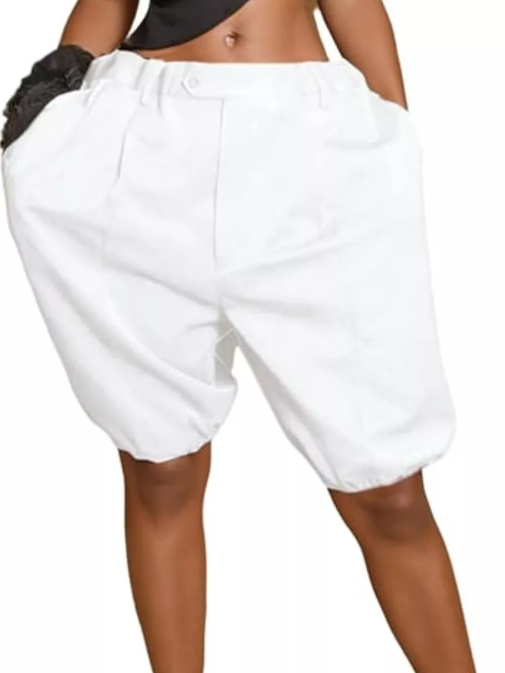 White pleated high-waisted shorts with drawstring and balloon leg detail.