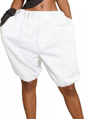 White pleated high-waisted shorts with drawstring and balloon leg detail.